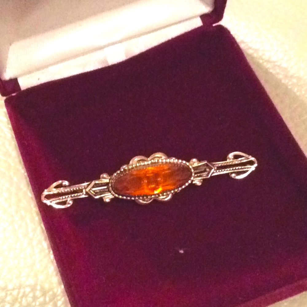 A orange stone brooch